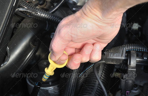 Automobile Maintenance – Pulling the Engine Dipstick to Check the Oil Level