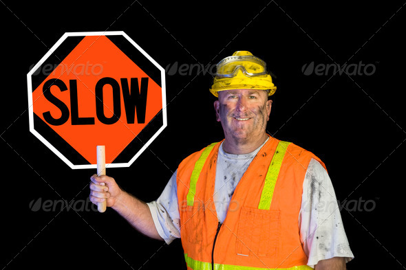 Dirty construction worker holding slow sign