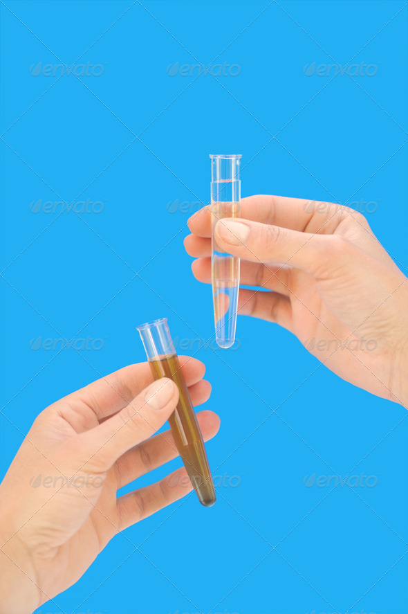 Hands holding clean and dirty water samples in test tubes - isolated - enviromental concept