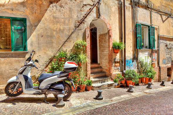 Motorcycle on cobbled street in Ventimiglia, Italy.