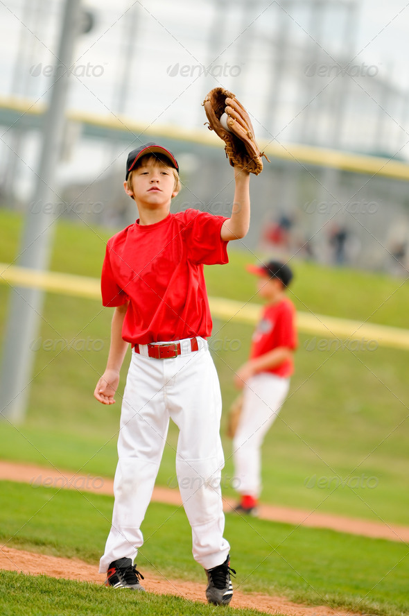 Youth baseball pitcher in red jersey