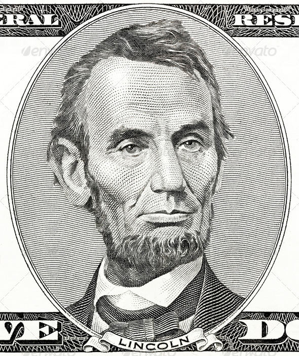 president Abraham Lincoln as he looks on five dollar bill obverse