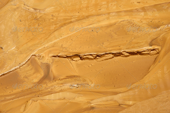 Yellow wet clay silt are photographed after a mud torrent. It is a rapid movement of a large mass of mud formed from loose soil and water.