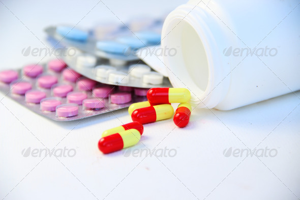 Mix of pills and tablets on the white background
