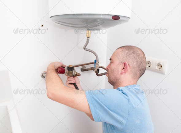 Plumber repairing an electric boiler
