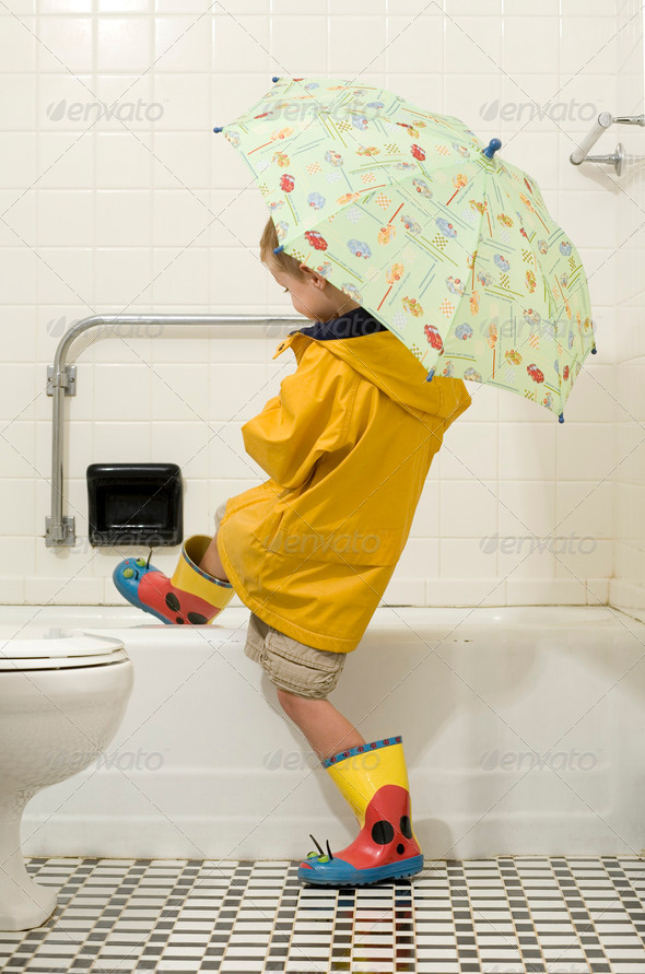 Child in Rain Gear Getting into the Tub