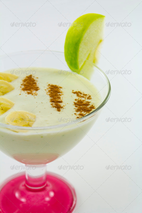 Milk shake with banana and cinnamon and apple on top.