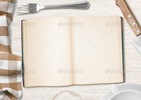 kitchen table with open book or copybook as a background for cooking recipe