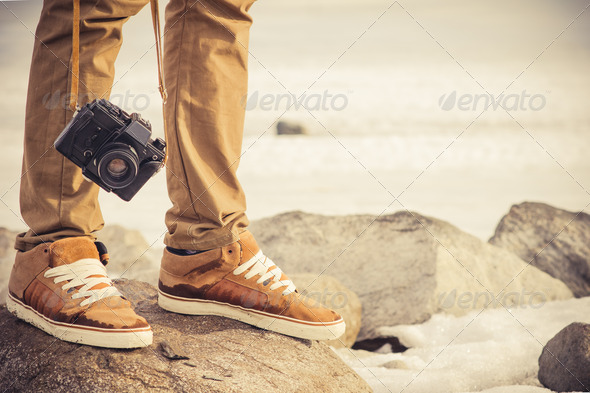Feet man and vintage retro photo camera outdoor Travel Lifestyle vacations concept