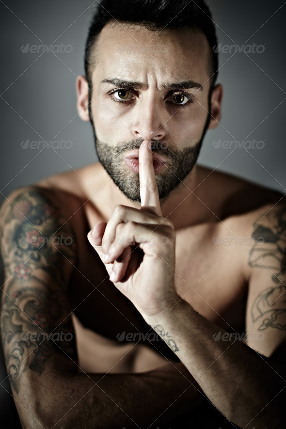 tattooed man with finger on mouth PhotoDune Item for Sale