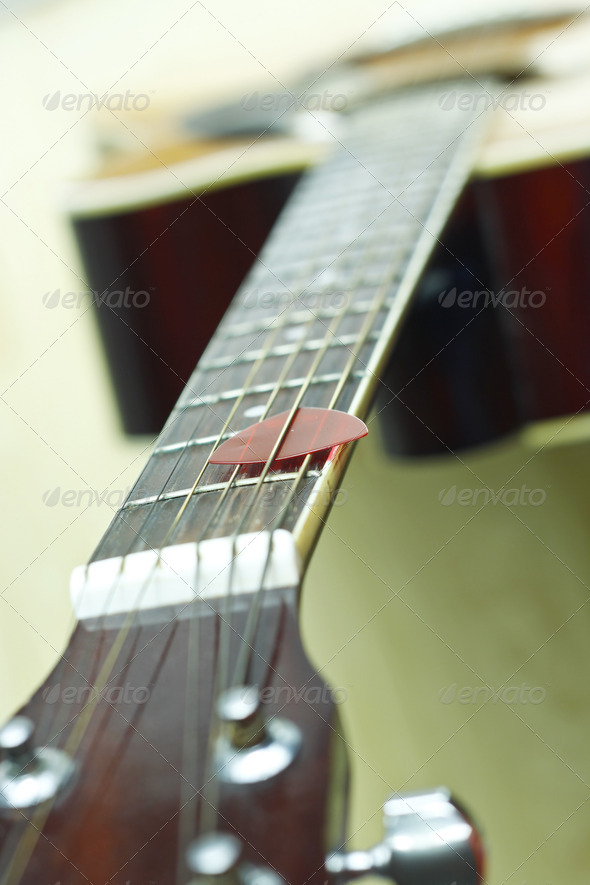 guitar pick on the fingerboard