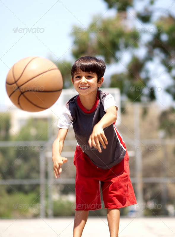 Young boy passing basketball