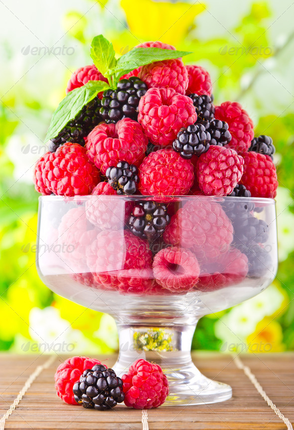 Sweet fresh fruits in glass goblet with mint leaf