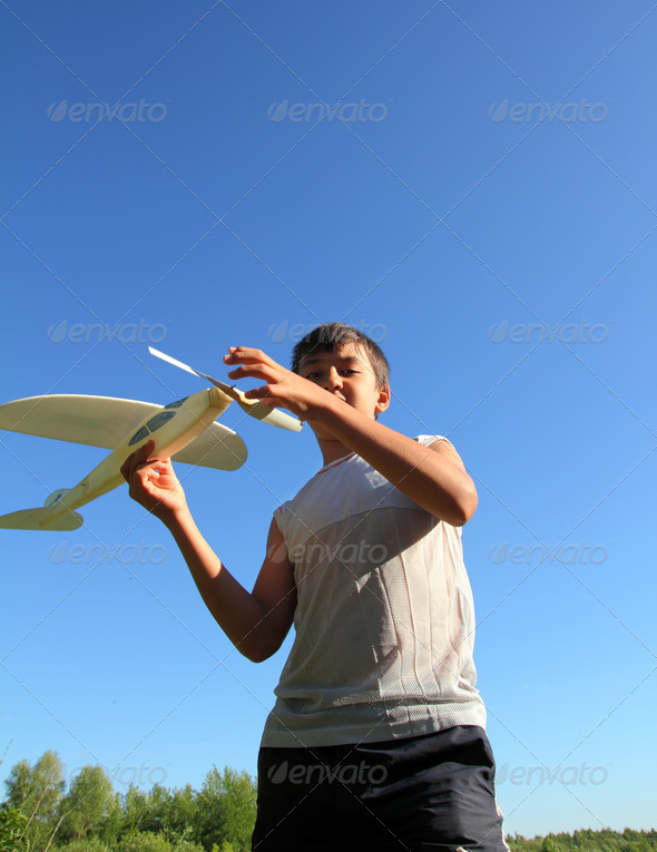 boy running airplane model