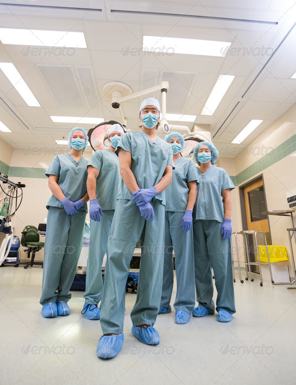 Medical Team In Scrubs Standing Inside Operation Room